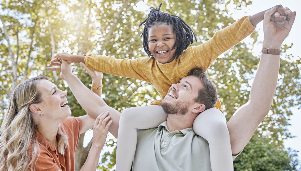 A foster family smiling and laughing