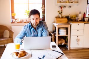 Male working from home in kitchen environment