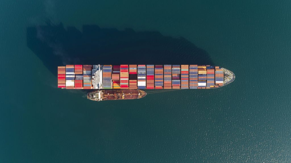 Large cargo ship receiving bunker fuel from a bunkering ship.