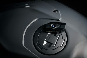 Close-up of a BMW key fob with sleek design and functional buttons for locking, unlocking, and remote access to the vehicle.