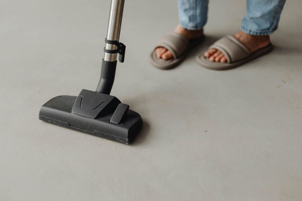 Professional installing hygienic flooring in a commercial space, showcasing a smooth, non-porous surface.