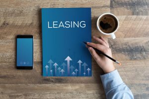 Open book with the word "Leasing" on a wooden table, symbolising lease extension guidance